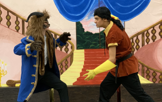 Two SJPII students acting in the Beauty and the Beast play