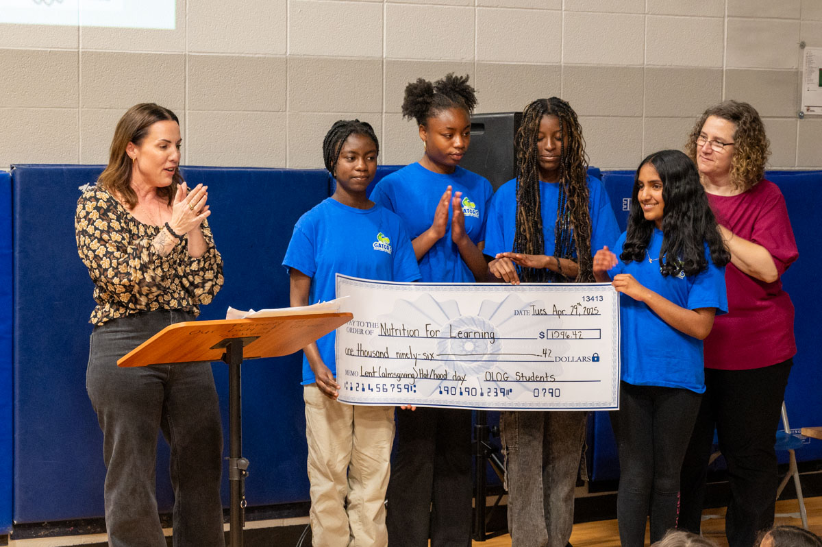 Students and Staff at Our Lady of Grace holding a big cheque for Nutrition for Learning