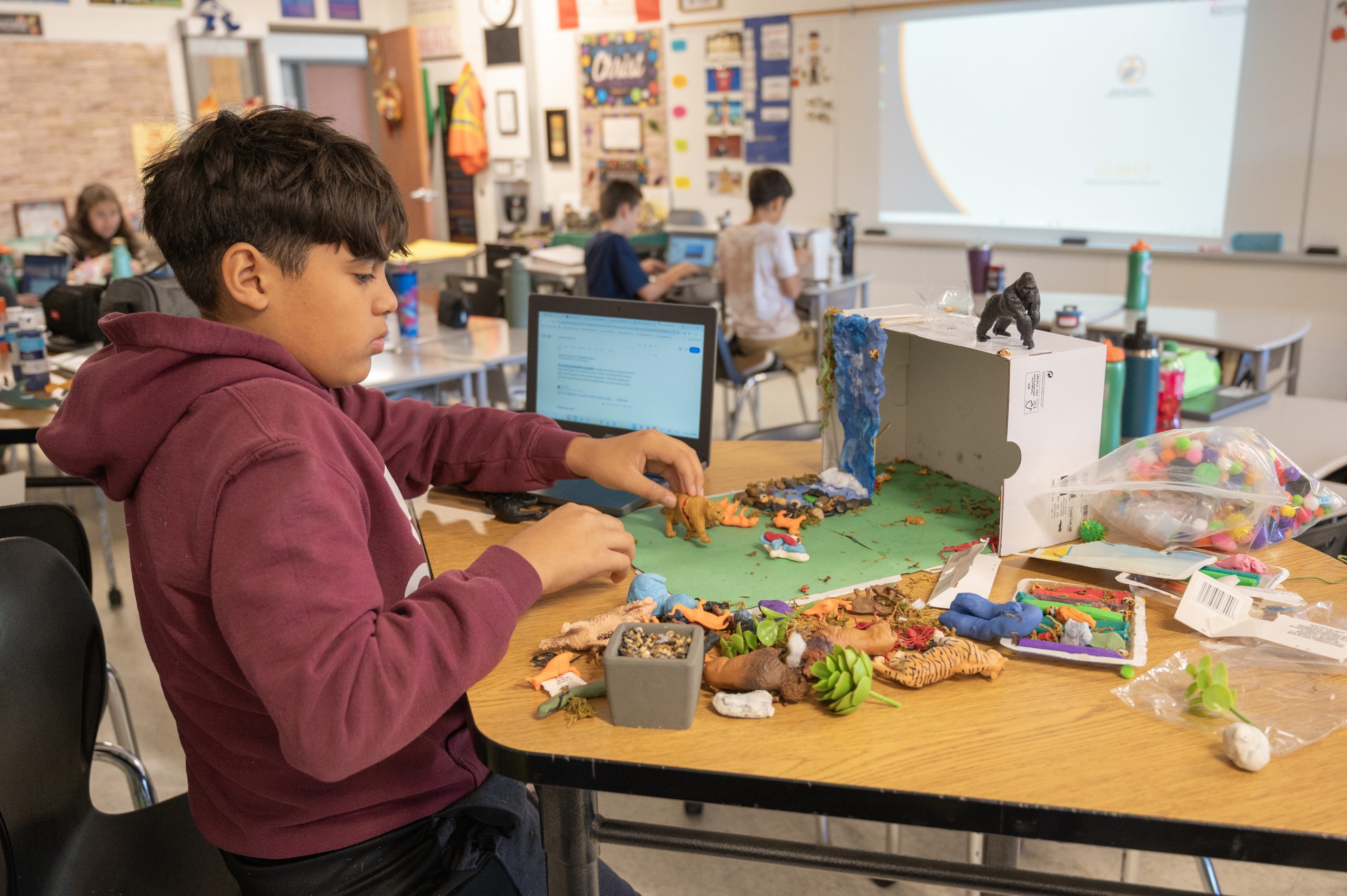 Student working on a diorama at school