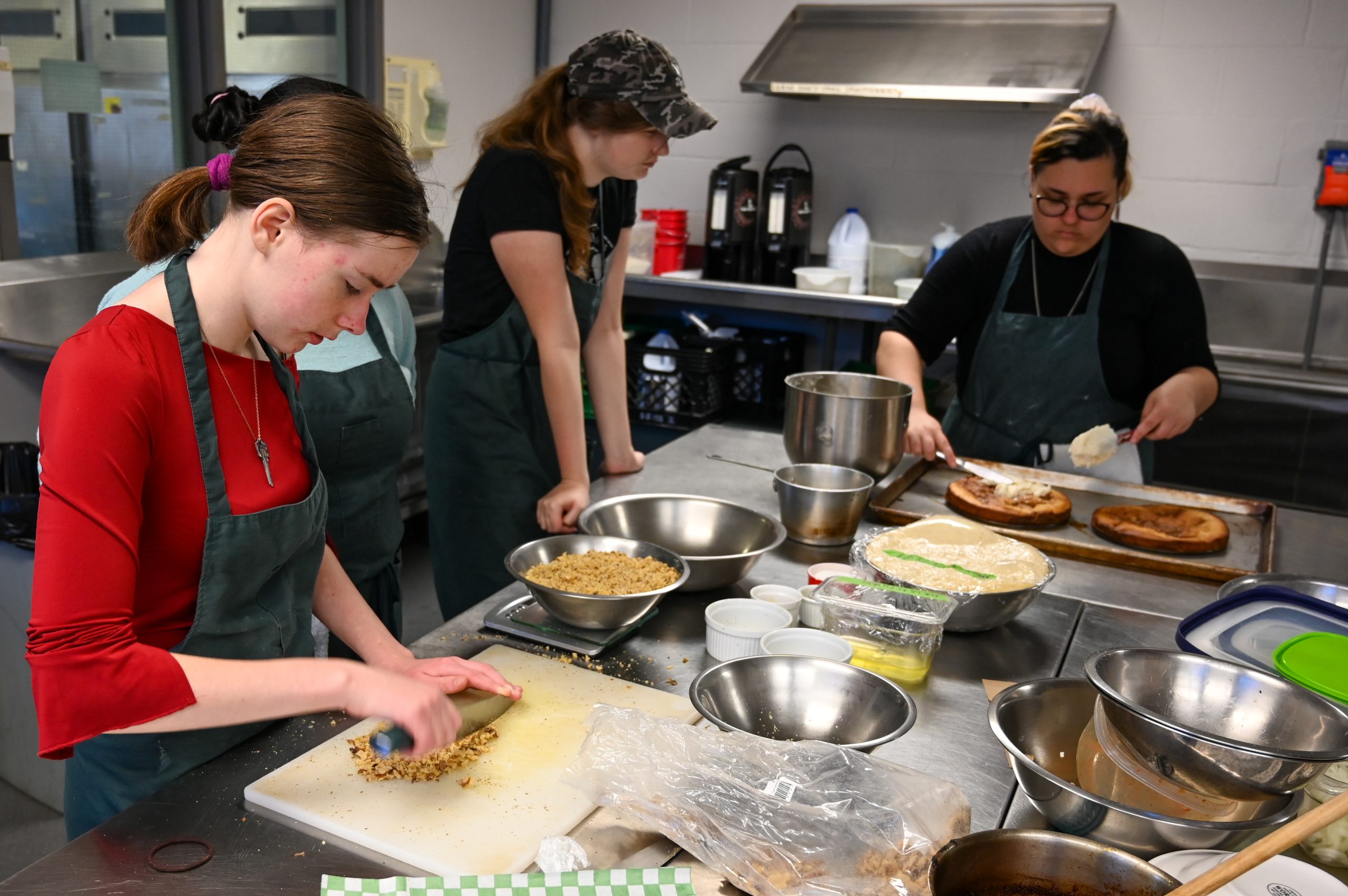 Students baking and cooking in a kitchen