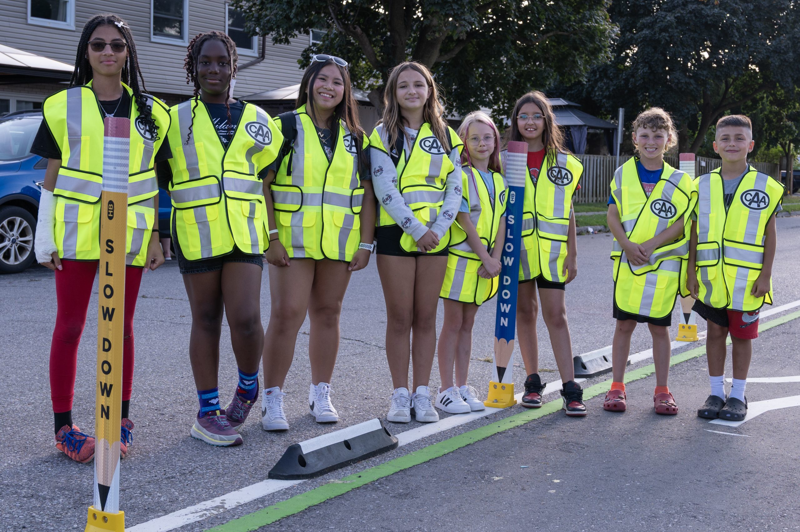 Students on the road wearing CAA reflective vests