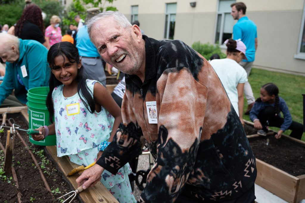 Students and Friends Gardening at Trinity Village
