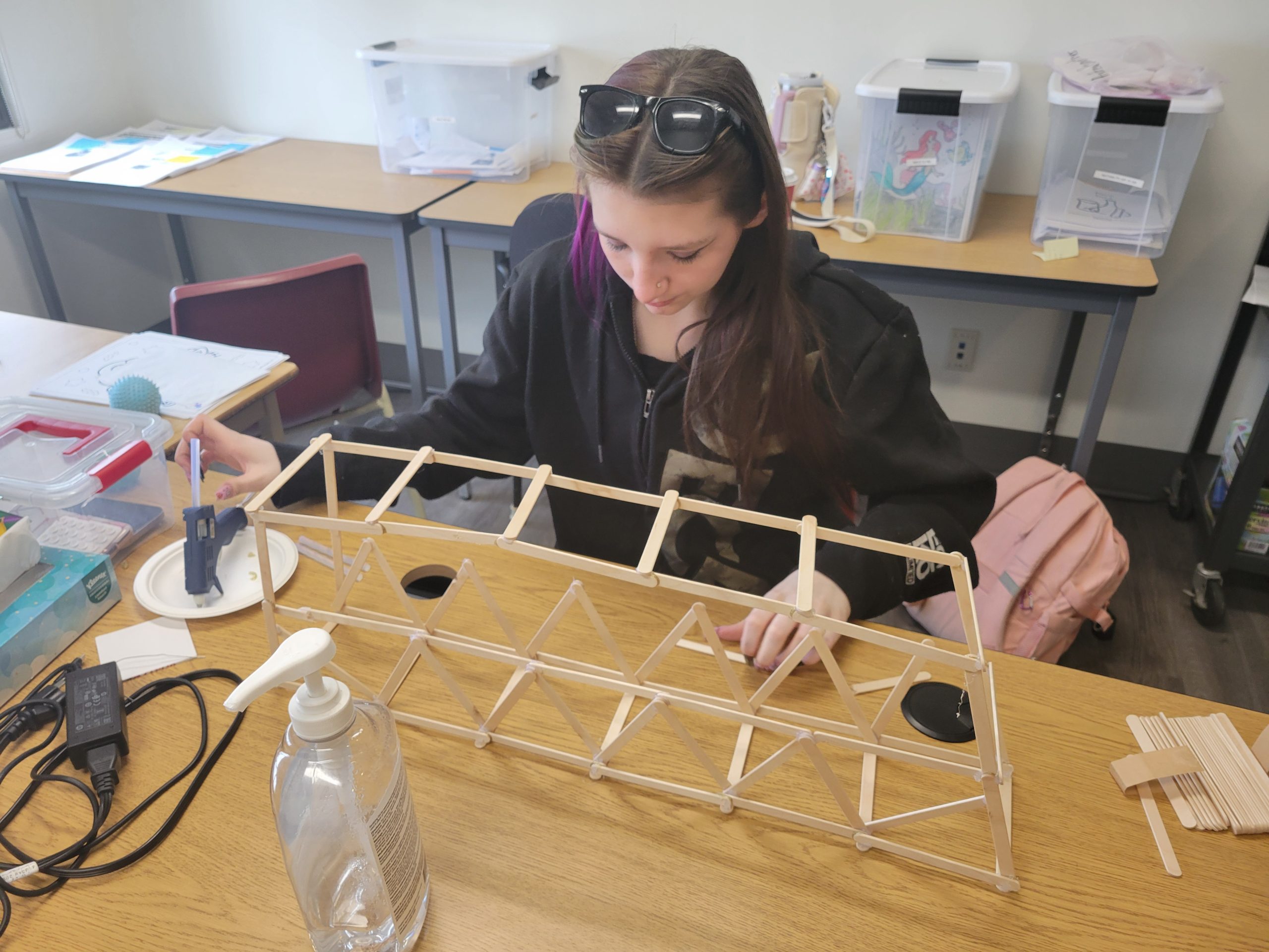 St. Don Bosco student creating a bridge out of popsicle sticks